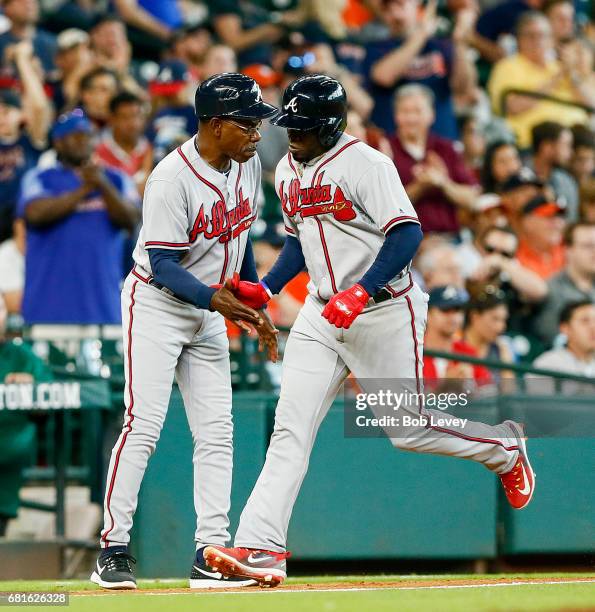 Atlanta Braves third baseman Adonis Garcia is congratulated by third base coach Ron Washington during a game against the Houston Astros at Minute...