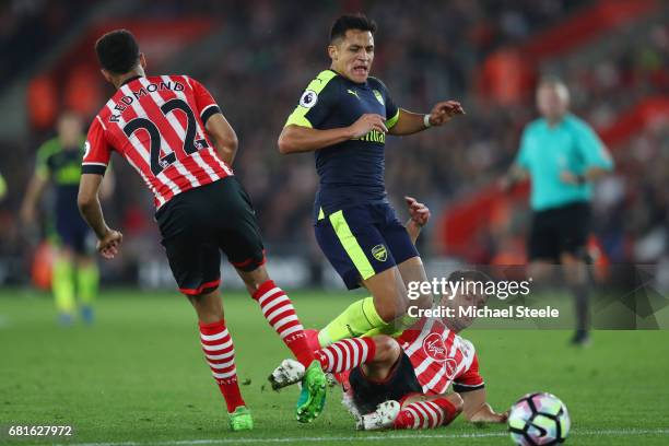 Alexis Sanchez of Arsenal is challenged by Cedric Soares of Southampton during the Premier League match between Southampton and Arsenal at St Mary's...