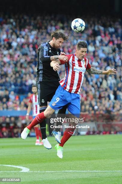 Sergio Ramos, #4 of Real Madrid and Fernando Torres, #9 of Atletico de Madrid during the UEFA Champions League quarter final first leg match between...