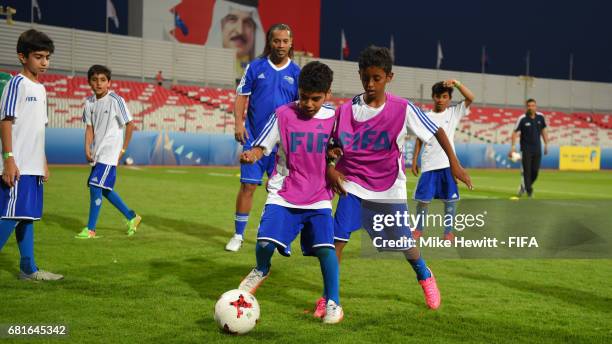 Legend Ronaldinho takes part during a grassroots training sesson with local children at the Bahrain National Stadium ahead of the 67th FIFA Congress...