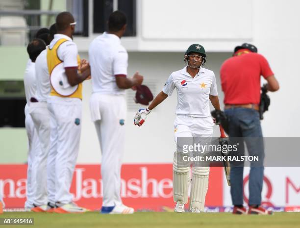 West Indies players form a guard of honour for batsman Younis Khan of Pakistan who is playing in his final test match, during the first day of play...