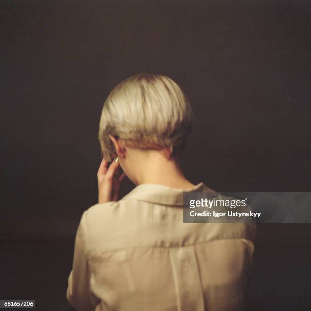 portrait of blond woman in studio - woman lipstick rearview stock-fotos und bilder