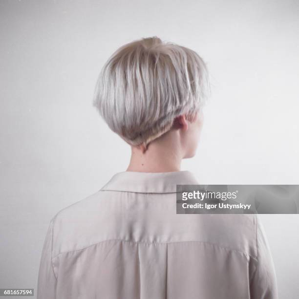 portrait of blond woman in studio - rückansicht stock-fotos und bilder