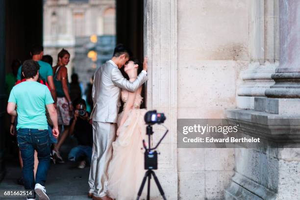 Couple takes wedding pictures at the Louvre, on August 28, 2016 in Paris, France. All over the year, couples come to take pictures in front of famous...