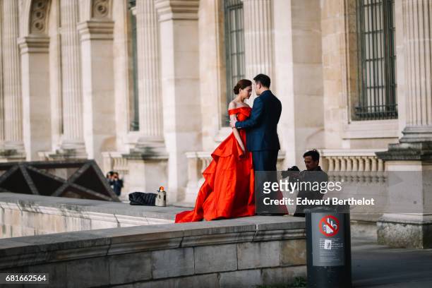 Couple takes wedding pictures at the Louvre, on April 16, 2016 in Paris, France. All over the year, couples come to take pictures in front of famous...