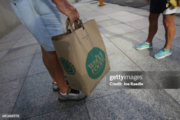 Customer carries his Whole Foods Market bag as the company appointed five new directors to its board and replaced its chairman on May 10, 2017 in...