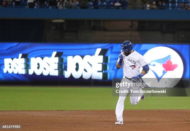 Jose Bautista of the Toronto Blue Jays is circles the bases after hitting a three-run home run in the first inning during MLB game action against the...