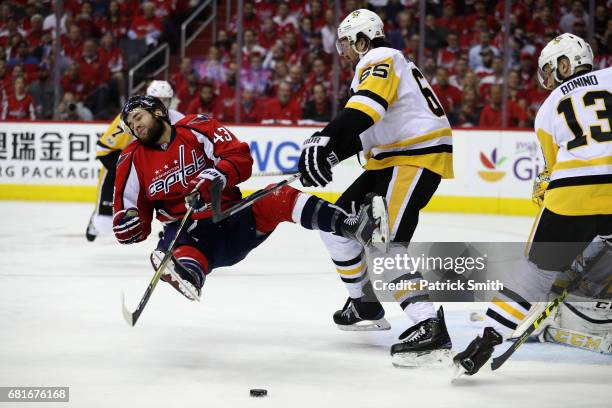 Tom Wilson of the Washington Capitals is checked by Ron Hainsey of the Pittsburgh Penguins in the first period in Game Seven of the Eastern...