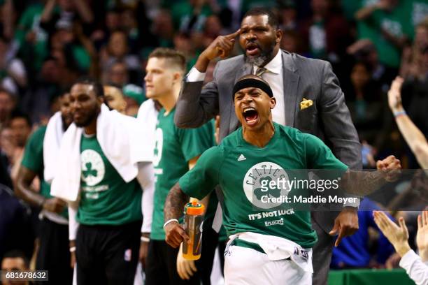 Isaiah Thomas and assistant coach Walter McCarty of the Boston Celtics react after Avery Bradley scored against the Washington Wizards during the...