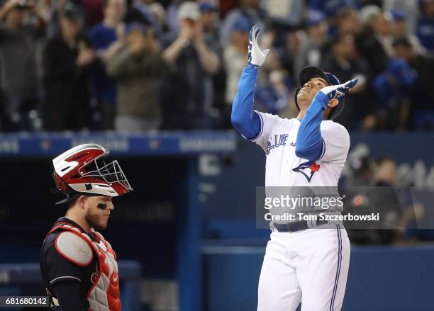 Ezequiel Carrera of the Toronto Blue Jays celebrates after hitting a two-run home run in the fourth inning during MLB game action as Roberto Perez of...