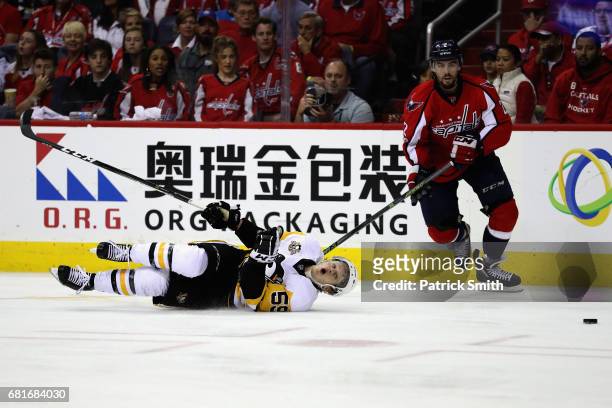 Jake Guentzel of the Pittsburgh Penguins and Matt Niskanen of the Washington Capitals go after the puck in the second period in Game Seven of the...