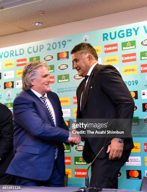 Director of Performance Scott Johnson of Scottland and Jamie Joseph head coach of Japan shake hands during a press conference after the Rugby World...