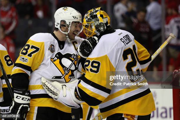 Sidney Crosby and goalie Marc-Andre Fleury of the Pittsburgh Penguins celebrate following the Penguins 2-0 win over the Washington Capitals in Game...