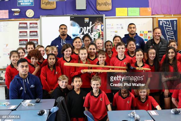 Stephen Perofeta, Jerome Kaino and Jimmy Tupou of the Blues pose with children during the New Zealand Lions Series Education Programme Launch at...