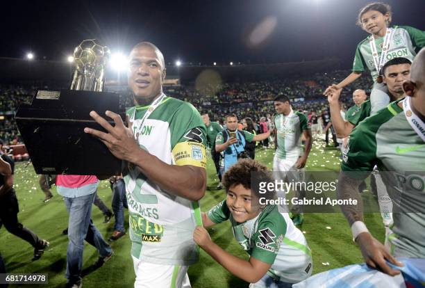 Alexis Henriquez of Nacional celebrates with the trophy after winning a match between Atletico Nacional and Chapecoense as part of CONMEBOL Recopa...