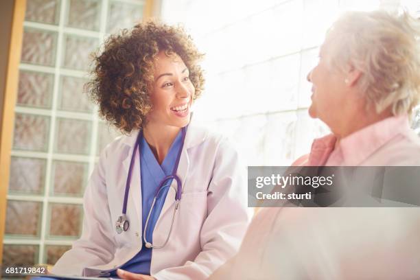 giving her patient the all clear - doctor giving good news stock pictures, royalty-free photos & images