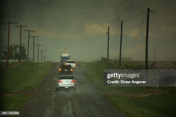 Caravan of storm chasers travels through hail as they chase a supercell thunderstorm, May 10, 2017 in Olustee, Oklahoma. Wednesday was the group's...