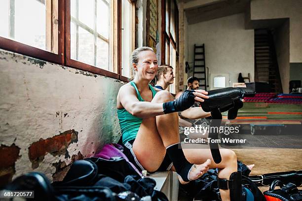 Muay thai boxer putting on protection gear