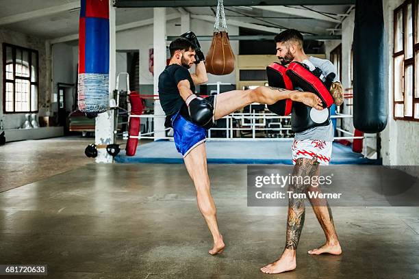 two muay thai boxing athletes during training - kickboxing stock pictures, royalty-free photos & images
