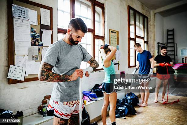 muay thai boxer getting ready for training session - boxing bag stock pictures, royalty-free photos & images