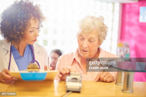 paying for her treatment - grandma invoice stock pictures, royalty-free photos & images