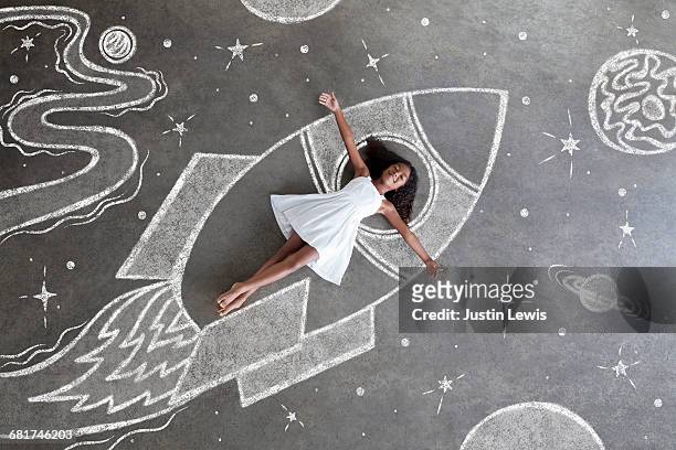 young black girl, white dress, imaginary spaceship - motivation stock-fotos und bilder