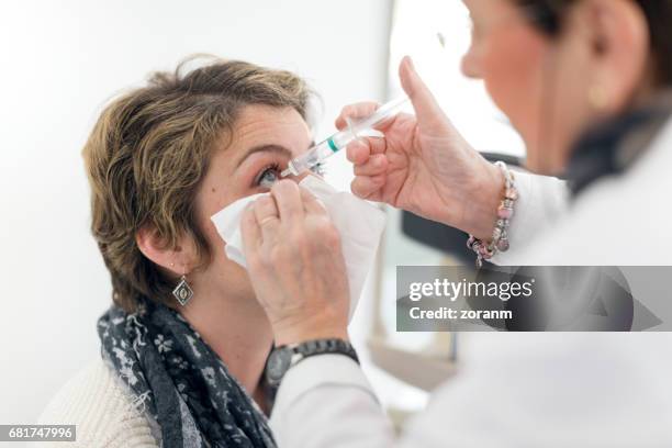 patient at eye doctor - needle stock pictures, royalty-free photos & images