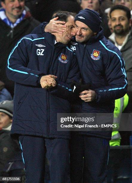 West Ham United manager Gianfranco Zola is congratulated by fitness coach Antonio Pintus, on the touchline after the final whistle.