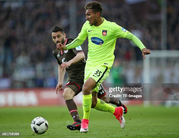 Cenk Sahin of FC St. Pauli and Kevin Lankford of 1. FC Heidenheim battle for the ball during the Second Bundesliga match between FC St. Pauli and 1....