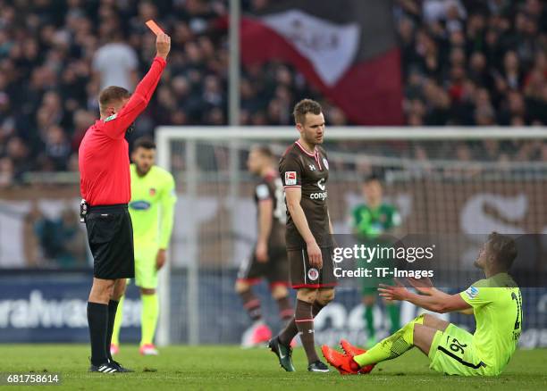 Referee Robert Schroeder show Marcel Titsch-Rivero 1. FC Heidenheim a red card during the Second Bundesliga match between FC St. Pauli and 1. FC...