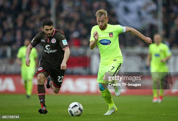 Cenk Sahin of FC St. Pauli and Marc Schnatterer of 1. FC Heidenheim battle for the ball during the Second Bundesliga match between FC St. Pauli and...