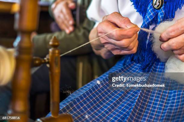 spinning wheel - seniorinnen stock pictures, royalty-free photos & images