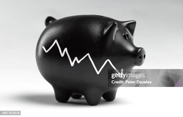 piggy bank with graph going down black monday - descente stock pictures, royalty-free photos & images