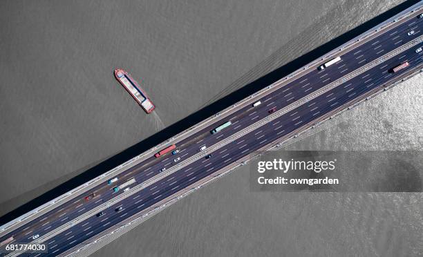 Aerial view of cars on bridge over river