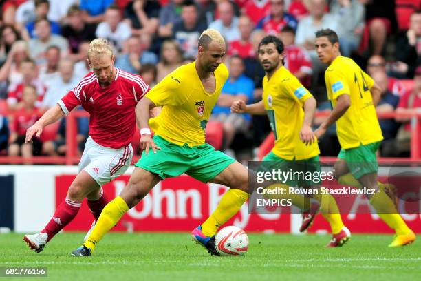 Nottingham Forest's Simon Gillet challenges Royal Antwerp's John Bostock for the ball.