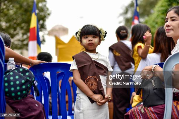 Young buddhist devotee girl pictured during Vesak day celebration in Kuala Lumpur, Malaysia, on May 10, 2017. Vesak day on the full-moon day of the...