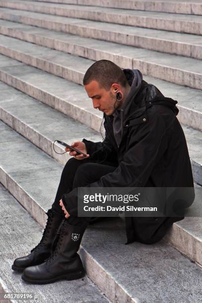 An Italian man sits on the steps of the Basilica di San Petronio in the Piazza Maggiore on March 29, 2017 in Bologna, Italy. Bologna has three...