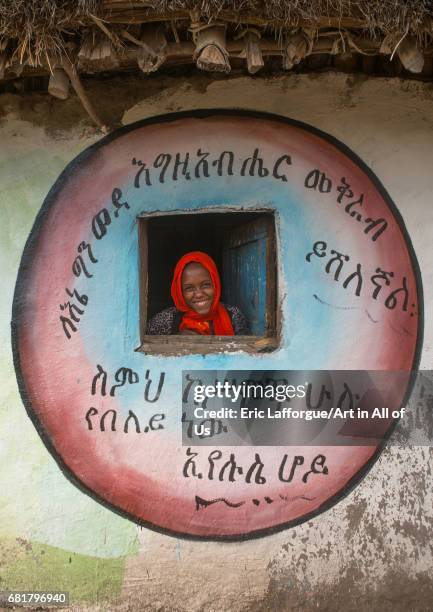 Ethiopian woman standing in the window of her traditional painted house, Kembata, Alaba Kuito, Ethiopia on March 8, 2016 in Alaba Kuito, Ethiopia.