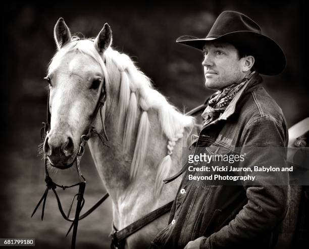 cowboy and beautiful blonde horse in black and white - cowboy black and white american male portrait stock pictures, royalty-free photos & images