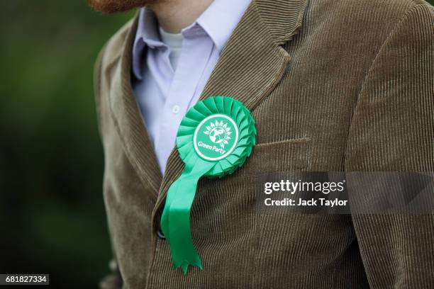 Green Party rosette sits on the lapel of a supporter's corduroy jacket as Co-Leader of the Green Party Caroline Lucas launches the party's...