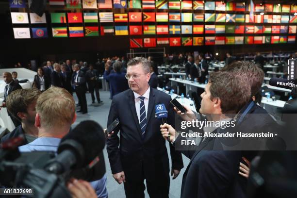 Council Member and President of the German Football Association Reinhard Grindel talks to the media after the 67th FIFA Congress at the Bahrain...