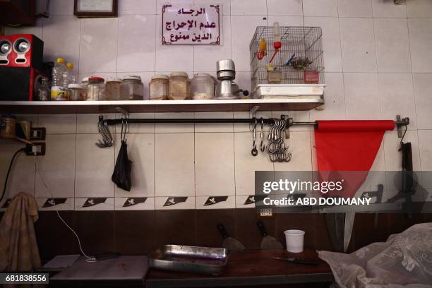 Picture shows a Syrian butcher shop in the rebel-held town of Douma, on the eastern outskirts of Damascus on May 11, 2017 Before the Syrian war the...