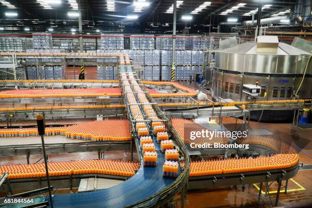 Plastic wrapped bottle packs of Fanta fruit soda move along the automated production line at the Coca-Cola Hellenic Bottling Co. SA plant in Brovary,...