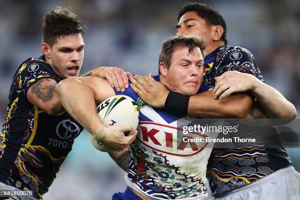 Brett Morris of the Bulldogs is tackled by the Cowboys defence during the round 10 NRL match between the Canterbury Bulldogs and the North Queensland...