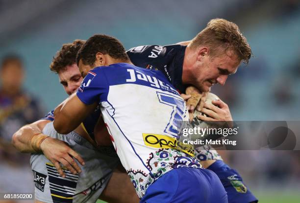 Coen Hess of the Cowboys is tackled during the round 10 NRL match between the Canterbury Bulldogs and the North Queensland Cowboys at ANZ Stadium on...