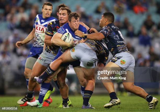 Brett Morris of the Bulldogs is tackled during the round 10 NRL match between the Canterbury Bulldogs and the North Queensland Cowboys at ANZ Stadium...