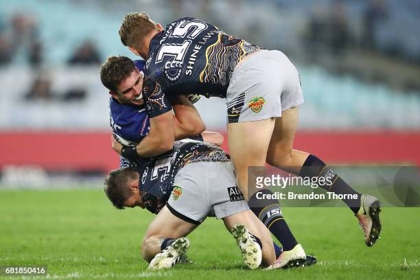 Adam Elliott of the Bulldogs is tackled by the Cowboys defence during the round 10 NRL match between the Canterbury Bulldogs and the North Queensland...