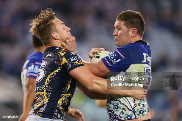 Greg Eastwood of the Bulldogs is tackled by Coen Hess of the Cowboys during the round 10 NRL match between the Canterbury Bulldogs and the North...