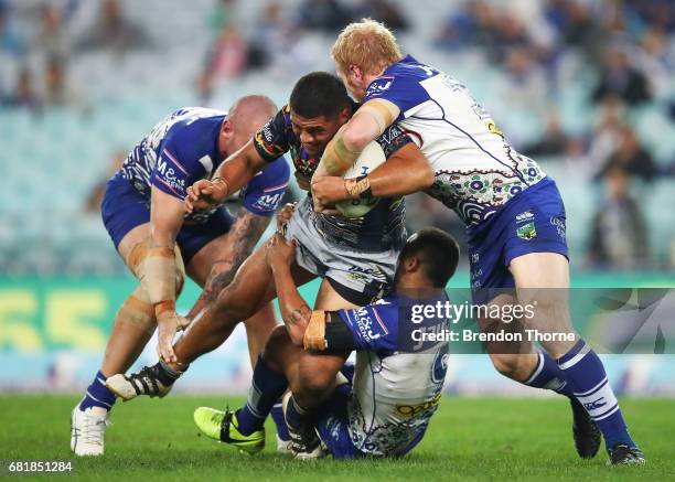 John Asiata of the Cowboys is tackled by the Bulldogs defence during the round 10 NRL match between the Canterbury Bulldogs and the North Queensland...