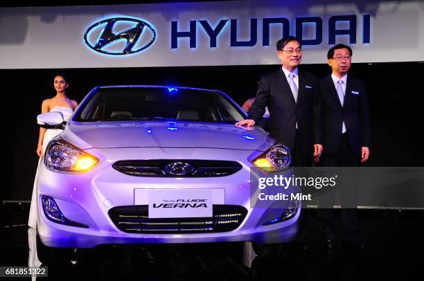 President and CEO of Hyundai Motors S. S. Yang and MD and CEO of HMIL H. W. Park along with a model pose for pictures during the launch of the...
